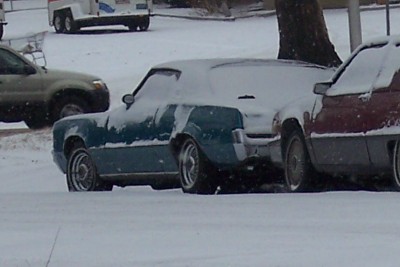 1972 Ford Ranchero - A 1972 Ford Ranchero is parked in the snow next to another vehicle.