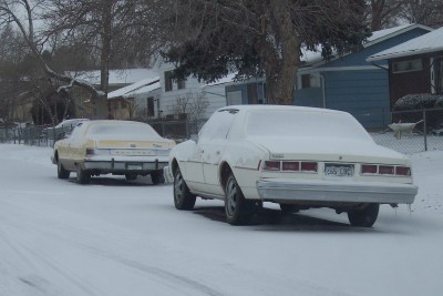 1972 Ford Ranchero - Two cars, one white and one yellow, are parked on a snow-covered street.