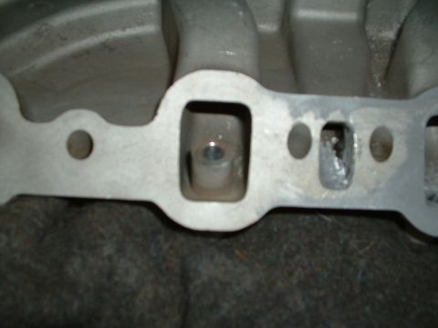 1978 Ford Bronco - Bottom of injector bung, Excess must be removed and runner shaped to original contour.