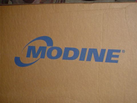 1984 Ford Bronco - Cardboard box with the Modine logo, likely containing a vehicle part.
