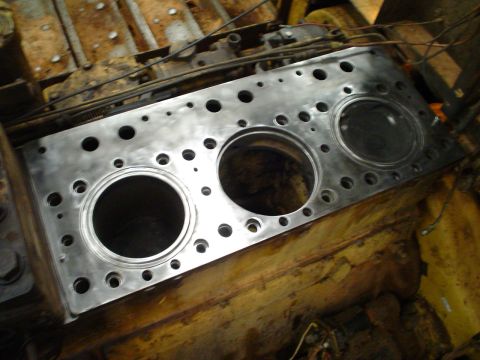 1966 International School Bus - A close-up view of a cleaned engine block, showing three cylinder bores and numerous bolt holes.