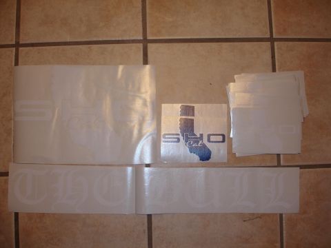 1993 Ford Taurus - Collection of white SHO Cal and script decals laid out on a tiled surface.