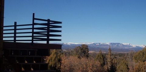 1986 Ford Ranger - A view of distant mountains from a deck, with a wooden railing in the foreground.