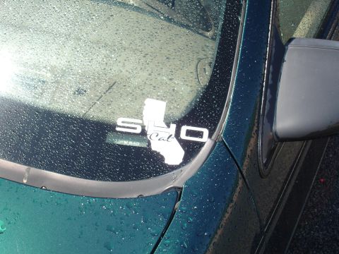 1993 Ford Taurus - A sticker on a wet windshield reads 'SHO Cal' with a California outline.