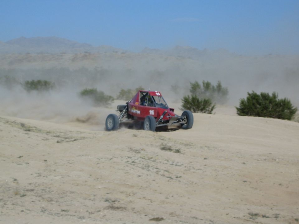 Red Hunter race buggy sliding through desert sand