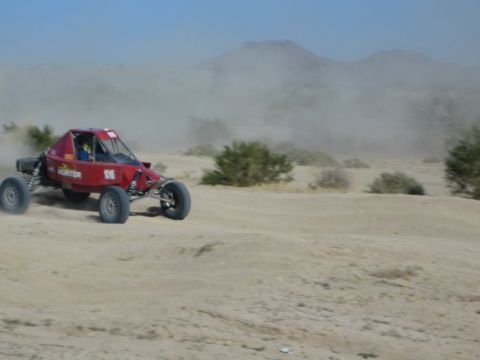 Red Hunter number 116 race buggy speeding in the desert