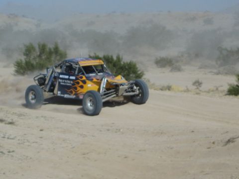 Orange flame-painted off-road race buggy in the desert