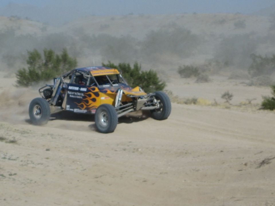 Orange flame-painted off-road race buggy in the desert
