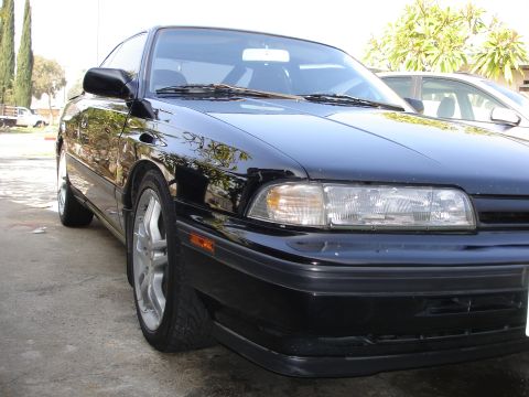 1989 Mazda MX-6 - Front 3/4 view of a black 1989 Mazda MX-6 coupe.