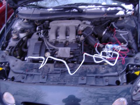 1998 Ford Taurus - The engine bay of a 1998 Ford Taurus shows some aftermarket wiring and modifications.