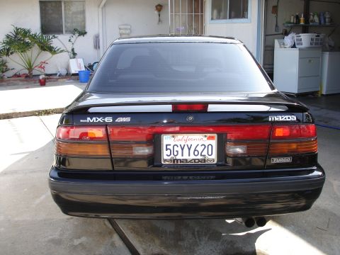 1989 Mazda MX-6 - Rear view of a black 1989 Mazda MX-6 GT Turbo, identified by its badging and taillight design.
