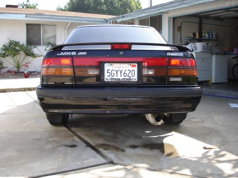 1989 Mazda MX-6 - Rear view of a 1989 Mazda MX-6, showing the taillights, spoiler, and license plate.