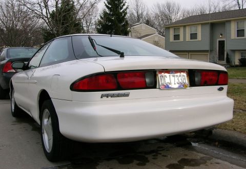 1997 Ford Probe - Rear view of a white 1997 Ford Probe, showing its distinctive taillights and the 'PROBE' badging.