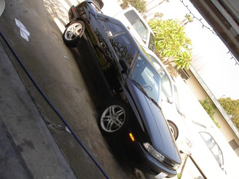 1989 Mazda MX-6 - A black 1989 Mazda MX-6 GT coupe is parked next to a white vehicle.
