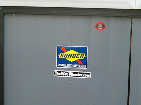 1986 Ford Bronco - A gray door displays Sunoco and TheWebWheeler.com stickers.