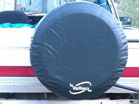 1986 Ford Bronco - A spare tire cover with a logo is visible on the rear of a vehicle.