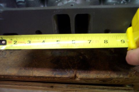 1978 Dodge Power Ram - Measuring the dimensions of an engine cylinder head with a tape measure.