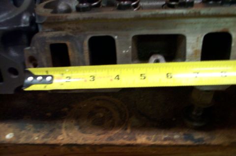 1978 Dodge Power Ram - A close-up of an engine cylinder head with a measuring tape is shown, indicating a measurement of about 3.5 inches.