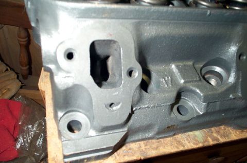 1978 Dodge Power Ram - Close-up view of a gray engine cylinder head, showing its internal structure and mounting points.