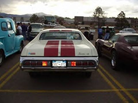 1972 Ford Ranchero - This 1972 Ford Ranchero features a distinctive white body with dual red racing stripes down the center.