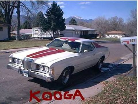 1972 Ford Ranchero - A white 1974 Mercury Cougar with red racing stripes is parked in a suburban driveway.