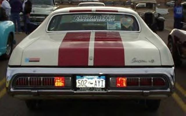1972 Ford Ranchero rear view, white with red stripes, chrome bumper, license plate 502 AYI