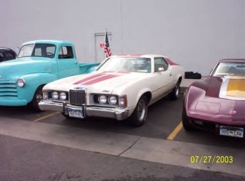 1972 Ford Ranchero - Three classic vehicles, including a 1972 Ford Ranchero, parked side-by-side in a lot.