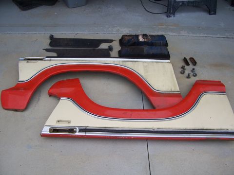 1978 Ford Bronco - Disassembled body panels and trim pieces are laid out on a concrete surface.
