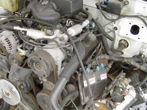 1991 Ford Bronco - Close-up view of a vehicle's engine compartment, showing intricate mechanical and electrical systems.