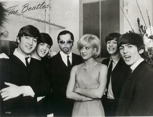 2002 Ford Crown Victoria - A black and white photo shows the band The Beatles with other individuals, with the band's name visible in the background.