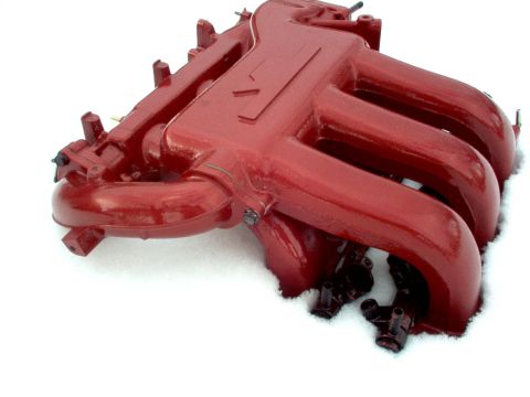 1994 Ford Probe - This red intake manifold is a replacement part, likely for a performance application, shown here in a snowy environment.