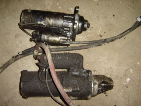 1992 Ford Bronco - Two starter motors are shown, likely removed from a vehicle for repair or replacement.