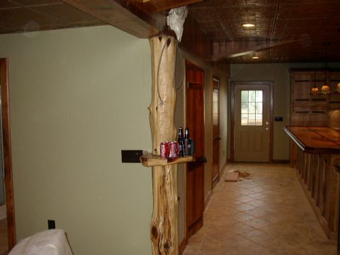 1995 Ford Bronco - A view down a hallway in a room with a rustic wooden pillar and a door at the end.