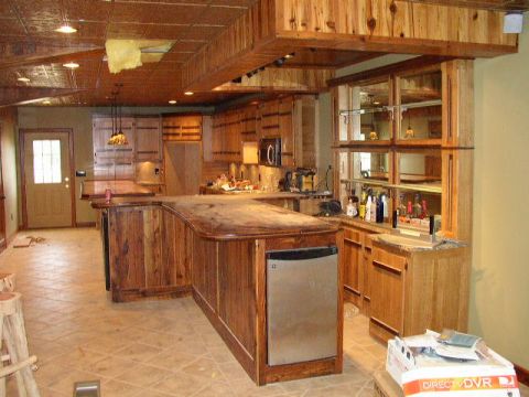 1995 Ford Bronco - A view of a kitchen with extensive wooden cabinetry and a large island, a Supermotors logo in the foreground.