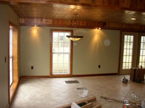 1995 Ford Bronco - Interior scene with wood-paneled ceiling, tiled floor, and large windows. Text overlay reads SUPERMOTORS.