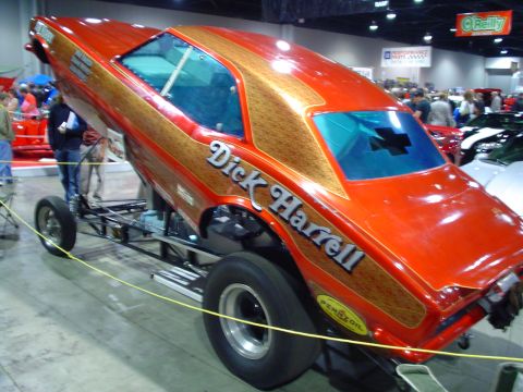 1984 Ford Bronco - This drag car features a distinctive orange and wood grain paint scheme with prominent lettering.