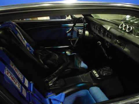 1984 Ford Bronco - Interior view of a modified car racing seats and custom dashboard gauges.