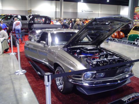1984 Ford Bronco - Customized 1969 Ford Mustang Mach 1 on display at a car show.