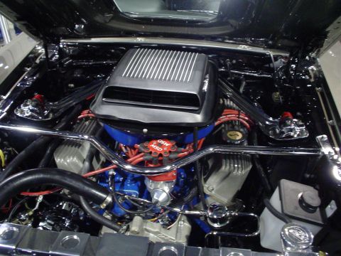 1984 Ford Bronco - Close-up view of a modified engine bay, a prominent air intake and various aftermarket components.