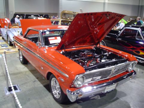 1984 Ford Bronco - This orange 1964 Ford Falcon coupe is displayed with its hood open, revealing the engine bay.