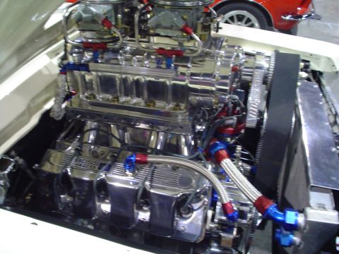 1984 Ford Bronco - A highly customized engine with a prominent supercharger and polished components is shown.