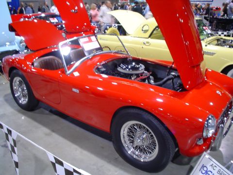 1984 Ford Bronco - A red sports car is displayed with its hood open, revealing the engine compartment.