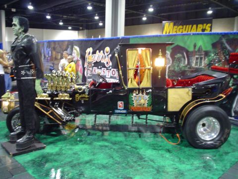 1984 Ford Bronco - A custom-built vehicle resembling a carriage, complete with a V8 engine and a Frankenstein figure, is displayed indoors.