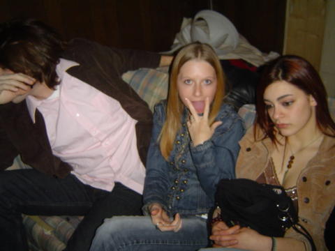 1998 Jeep TJ - Three people are sitting on a couch indoors.
