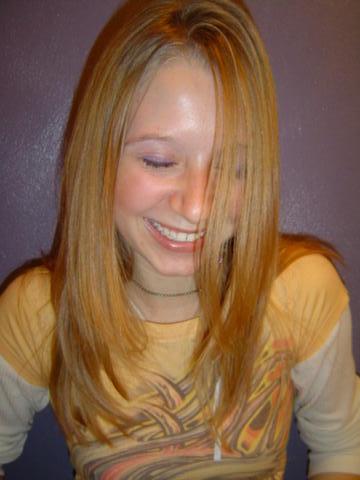 1998 Jeep TJ - A young woman smiles broadly, her eyes closed and hair falling over her face. A website logo is visible at the bottom of the image.