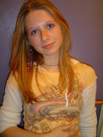 1998 Jeep TJ - A woman poses for a photo, wearing a graphic t-shirt over a long-sleeved shirt.