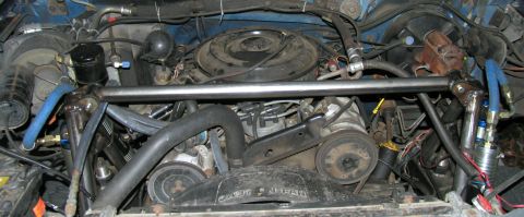 1984 Ford Bronco - Engine bay details with visible hoses and engine parts, likely modified.