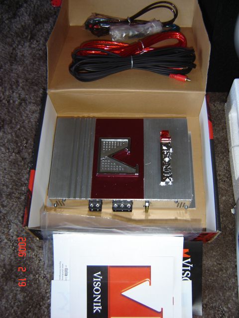 1993 Ford Bronco - A car amplifier and wiring kit are shown inside a cardboard box, with product documentation visible below.