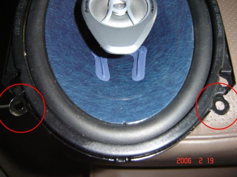 1993 Ford Bronco - Close-up of a car speaker, showing its blue cone and silver tweeter with mounting points highlighted.