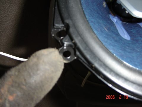 1993 Ford Bronco - Gloved hand near speaker mounting bracket, with visible text '2006 2 19 SUPERMOTORS.NET'.
